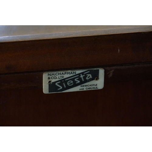 565 - A 1930s Walnut & Mahogany Bookcase with Astragal Glazed End Doors & a panelled centre door & resting... 