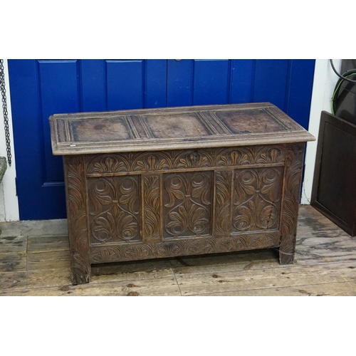 571 - An Antique Carved Oak Three Panelled Coffer with Floral decoration. Measuring: 115cms across x 57cms... 