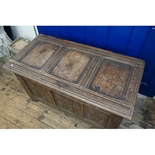 571 - An Antique Carved Oak Three Panelled Coffer with Floral decoration. Measuring: 115cms across x 57cms... 