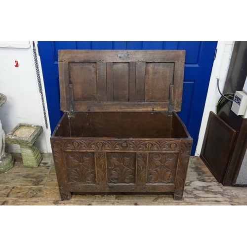 571 - An Antique Carved Oak Three Panelled Coffer with Floral decoration. Measuring: 115cms across x 57cms... 