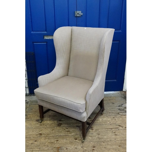 577 - An Antique Georgian design Grand Sire Chair with swept out semi-wing & standing on square legs with ... 