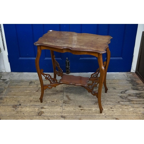 583 - A carved wooden side table with under tier made by 