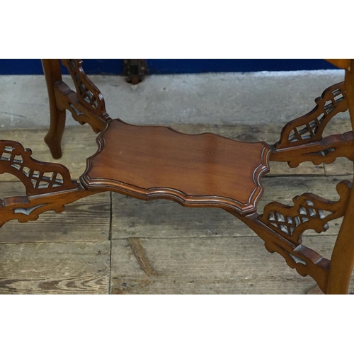 583 - A carved wooden side table with under tier made by 