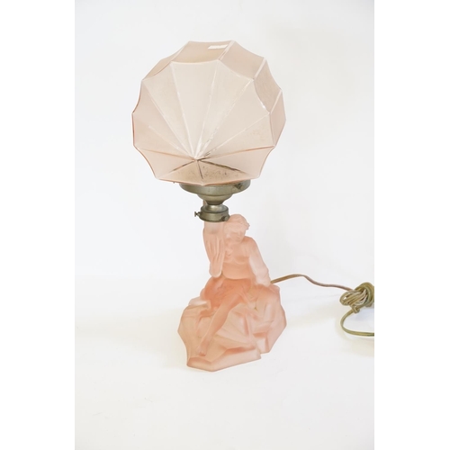 317 - A 1920s pink dressing table lamp with a young lady on a rock.