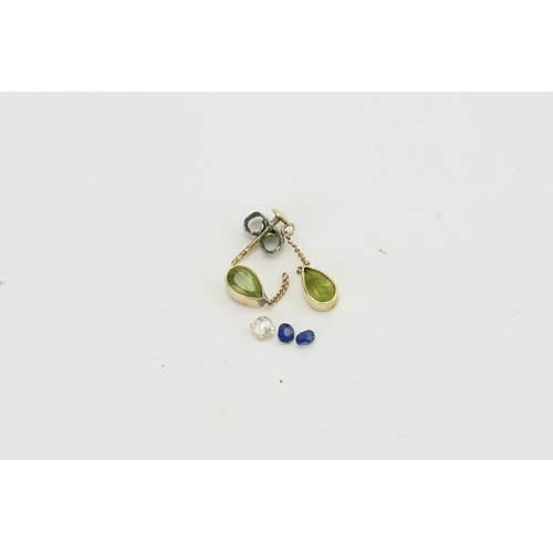 85 - A 0.15ct old cut loose diamond, along with two loose Sapphires, a pair of peridot stones.