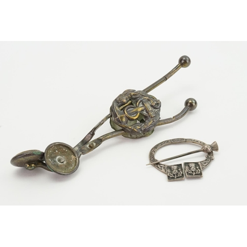 142 - A Scottish Kilt Pin & a pair of Kilt Lifters with a Naval Ensignia.