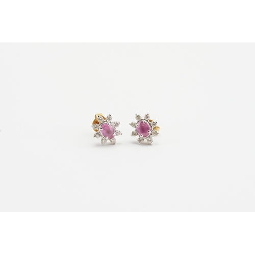 113 - A pair of 18ct gold diamond and pink sapphire earrings, in the floral design, set with eight diamond... 