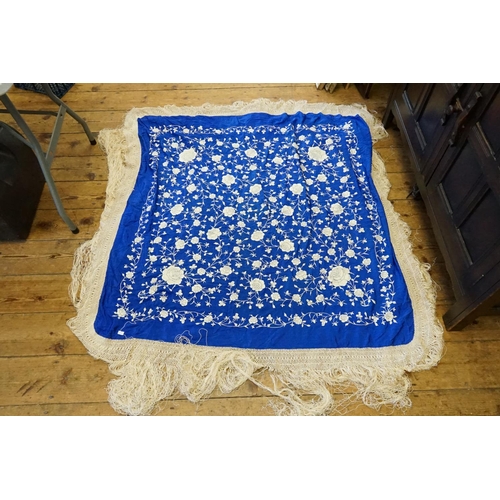 297 - A Chinese Electric Blue & embroidered Shawl with a long fringe.