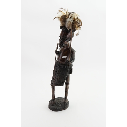 639 - A Carved Wooden Study of an African Warrior with War Apron & Spears. Measuring: 54cms high.