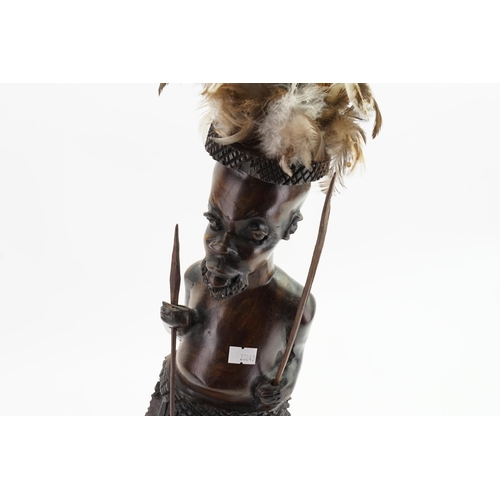 639 - A Carved Wooden Study of an African Warrior with War Apron & Spears. Measuring: 54cms high.