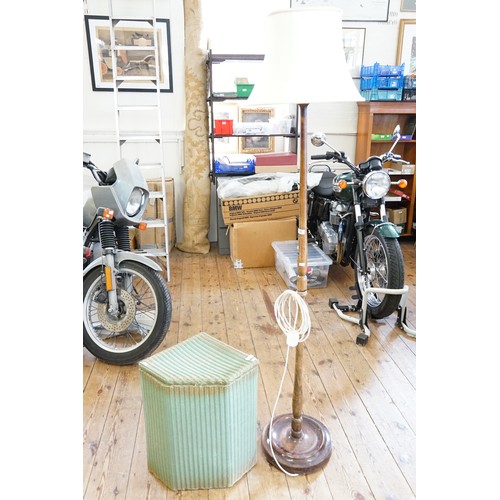 541 - A turned beech standard lamp and a Lloyd Loom linen basket.