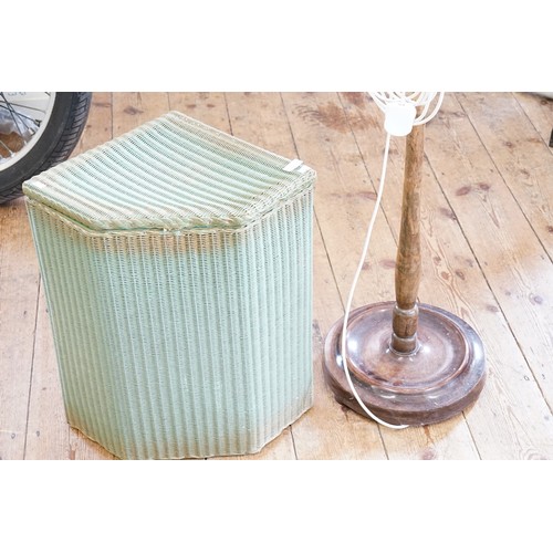 541 - A turned beech standard lamp and a Lloyd Loom linen basket.