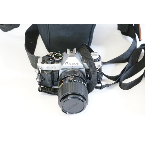 358 - A Canon AE1 Camera with Lens & Flash in a Centon Bag.