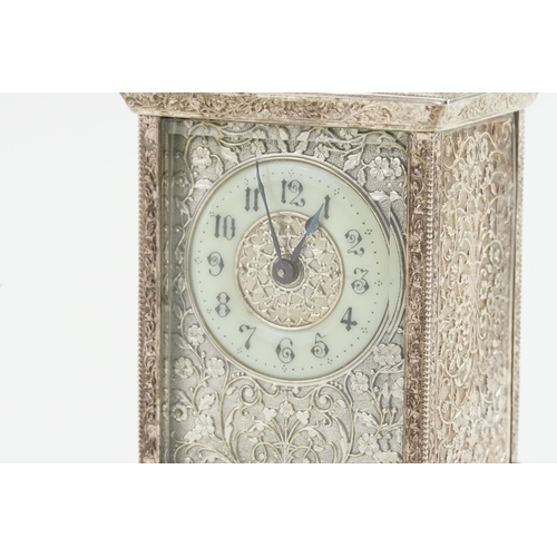 197 - A French Silver Plated & Dye Stamped Carriage Clock with Circular Chaptering with various flowers & ... 