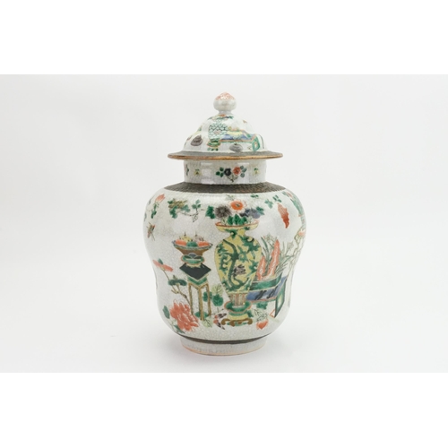 393 - A Japanese Crackle Glazed Green, Rust & Blue Garden Scene Jar & Cover. Measuring: 32cms High.