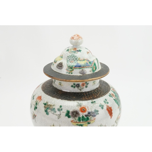 393 - A Japanese Crackle Glazed Green, Rust & Blue Garden Scene Jar & Cover. Measuring: 32cms High.