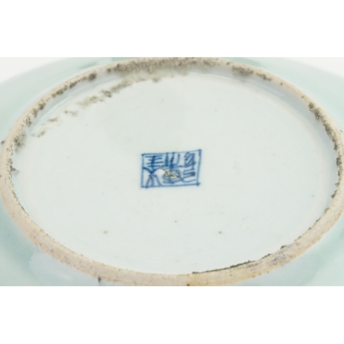 389 - A Chinese Celadon Glazed Plate decorated with a Bird. Measuring: 13cms across.