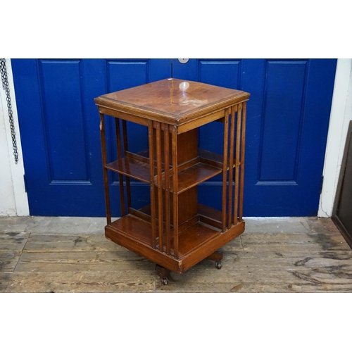 499 - A Chestnut Revolving Book Case with Splat Sides. Measuring: 49cms x 49cms x 84cms high.