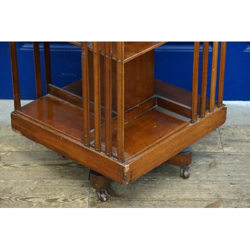 499 - A Chestnut Revolving Book Case with Splat Sides. Measuring: 49cms x 49cms x 84cms high.