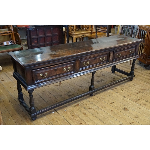 501 - An Antique Oak Dresser fitted with Three Drawers, Brass Swan Neck Handles, Two Plank Top, Turned Leg... 