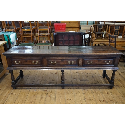 501 - An Antique Oak Dresser fitted with Three Drawers, Brass Swan Neck Handles, Two Plank Top, Turned Leg... 