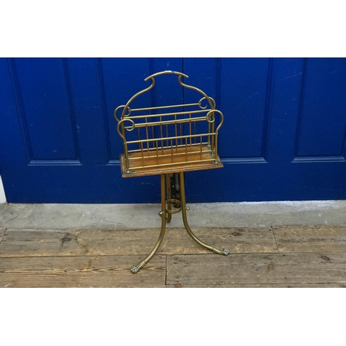 491 - An Edwardian brass and oak mounted magazine rack. Resting on splayed legs.