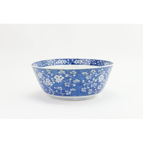 390 - A Chinese blue and white floral decorated large bowl, possibly marked with the four character mark o... 