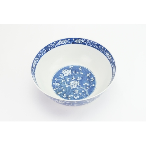 390 - A Chinese blue and white floral decorated large bowl, possibly marked with the four character mark o... 