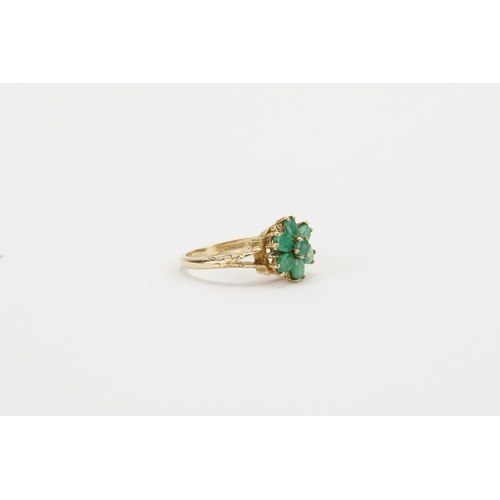 112 - A 9ct gold and green gem set ring, set with 7 green gems. Engraved decoration. Size Q. Weight 4.1g.