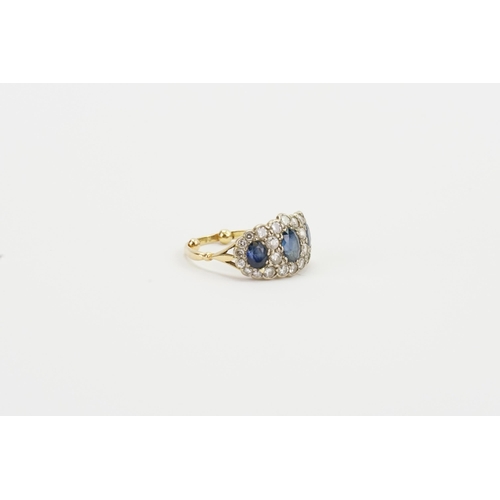 114 - A 18ct gold diamond and sapphire set ring. Set with three sapphires, the largest approximately 6mm x... 