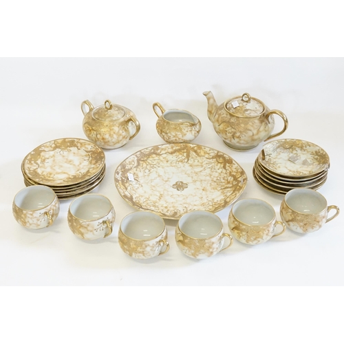 359 - A Tea Set decorated with Floral Gilt Decoration on a marbled background.