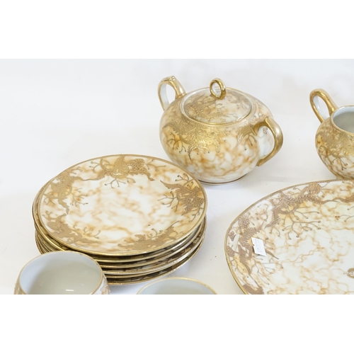 359 - A Tea Set decorated with Floral Gilt Decoration on a marbled background.