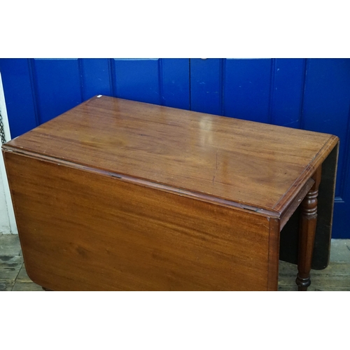 479 - A Victorian Mahogany Drop-Flap Table resting on turned & fluted legs. Measuring: 103cms long x 54cms... 