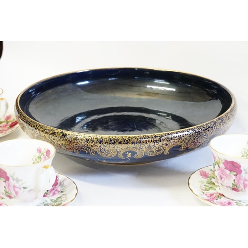 355 - A Blue Glazed Gold Burnished Floral decorated Centre Bowl. Measuring: 38cms across. Along with Three... 