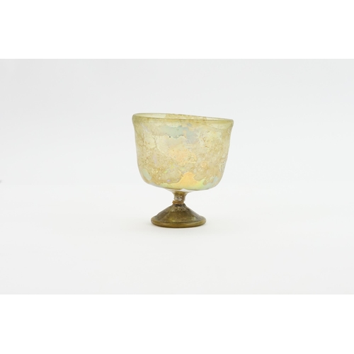 549 - A Roman Glass (?) iridescent Wine Glass on a fluted stem. (AF).