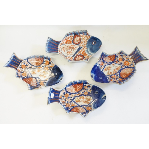 406 - Four Japanese Imari pattern Fish Shaped Saucer Dishes decorated in Rust, Blue & Cream, signed.