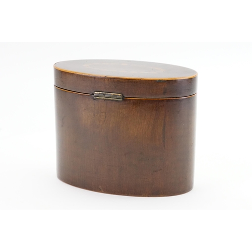 578 - A Georgian inlaid tea caddy in an oval design. 15cm wide by 12.5cm high.