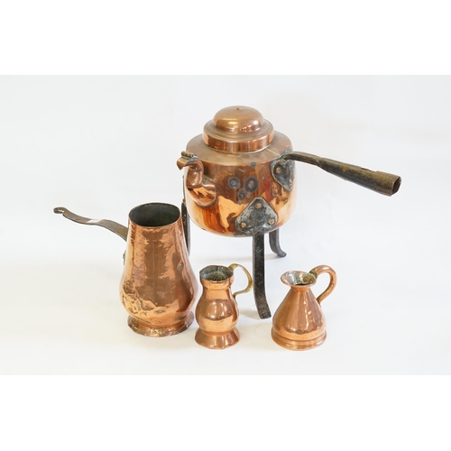 616 - A Collection of copper items to include jugs, pourer & a kettle on a fitted stand.