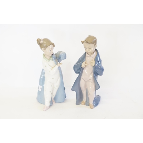 368C - A Pair of Nao figurines to include No: 1319 a Boy dressed in a Blue Dressing Gown & No: 1316 a Girl ... 