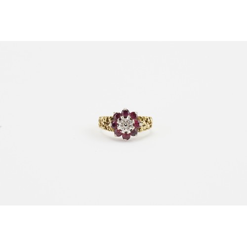 110 - A 18ct gold diamond & ruby cluster ring. Set with 8 small rubies. Size P. Weight 5.4g