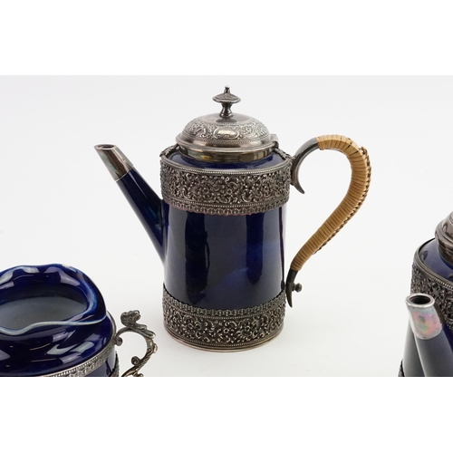 84 - An 1893 Doulton Lambeth Royal blue and Silver mounted Coffee and Tea set, mounted in silver with mak... 