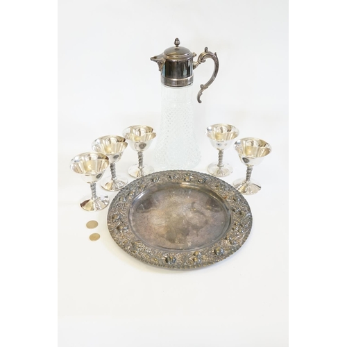 122 - A silver plated bread board base, a claret jug & five wine glasses.