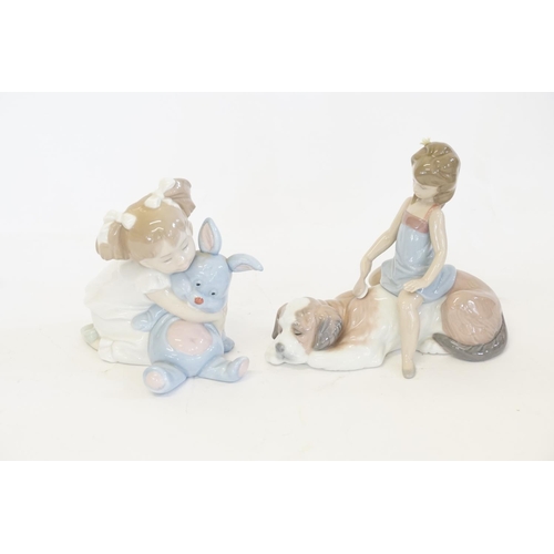 1000 - A Lladro Figurine of a Girl sat on a Dog along with a Nao Figurine of a Girl cuddling a Toy Rabbit.