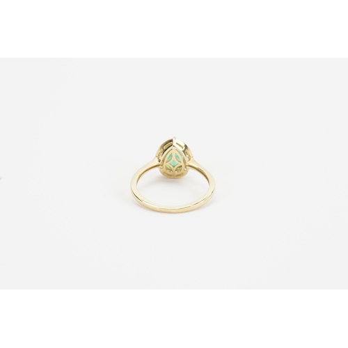 282 - A 9ct pear cut emerald ring (approx 1ct) surrounded by baguette diamonds. Weight 2.4g.