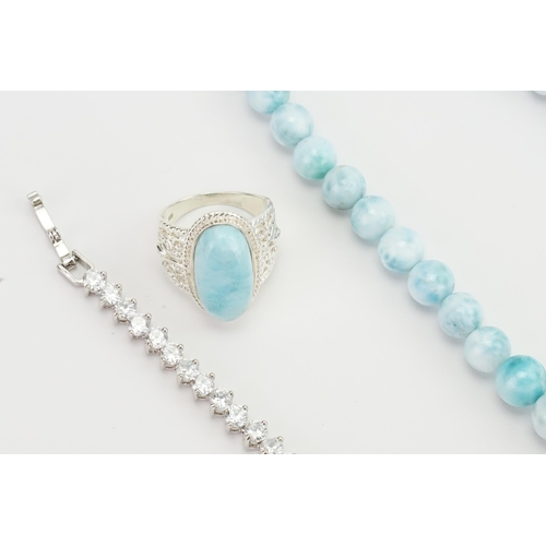 280 - A blue stone silver set bead necklace, along with a similar silver ring, and a paste tennis bracelet... 