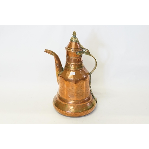 959 - A Syrian Caucasian Beaten Copper Water Pot with a Curved Brass Handle. Measuring: 35cms High.