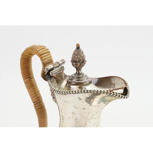 112 - An Adams design Sheffield Silver Plated Hot Water Jug with a Pineapple Finial & a Cane Handle.