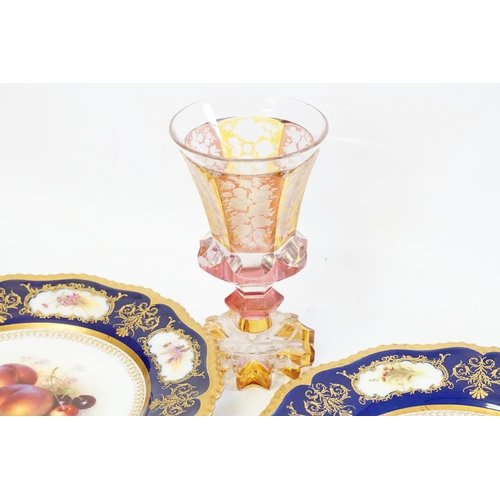 809 - A Bohemian Amber & Ruby Flash Cut Goblet resting on a faceted base, two Derby Plates & a Bocage Orna... 