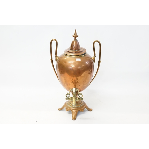 957 - A Regency Copper Twin Handled Adams design Hot Water Ern with Tap resting on a shaped base.