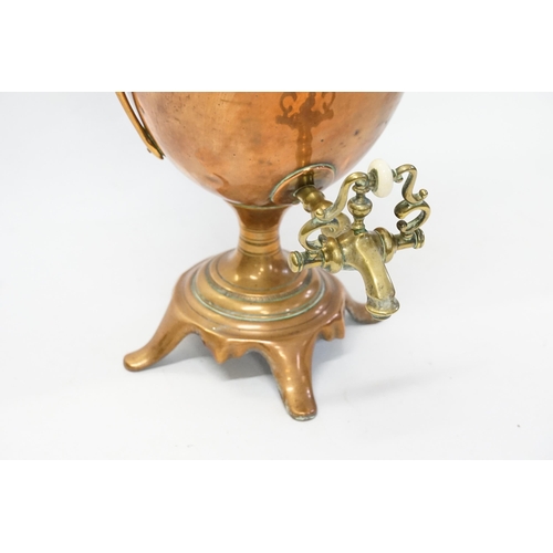 957 - A Regency Copper Twin Handled Adams design Hot Water Ern with Tap resting on a shaped base.